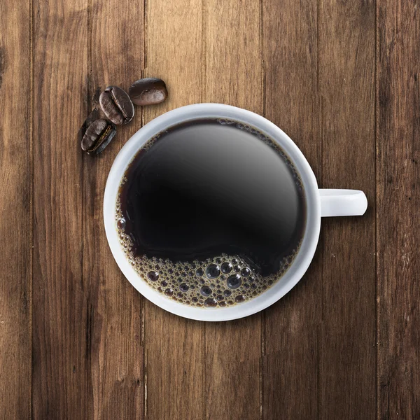 Xícara de café quente na mesa de madeira — Fotografia de Stock