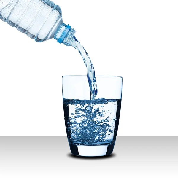 Water pour from water bottle to glass — Stock Photo, Image