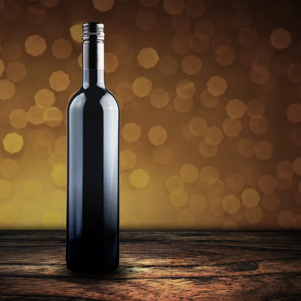 Wine bottle on wood floor — Stock Photo, Image