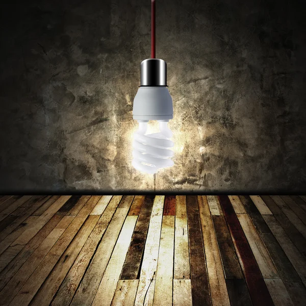 Light bulb in empty room — Stock Photo, Image