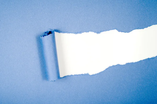 Ripped in blue paper on white — Stock Photo, Image