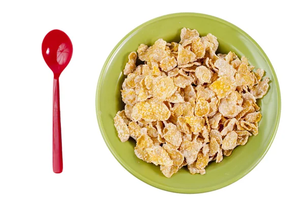 Bowl and spoon with corn flakes — Stock Photo, Image