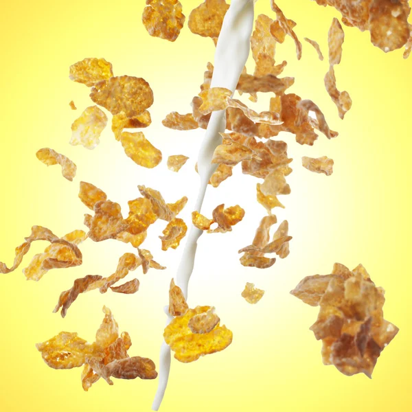 Corn Flakes and milk on yellow background — Stock Photo, Image