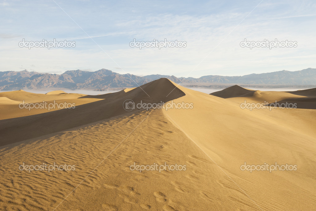 Desert landscape with mountain and sand dunes