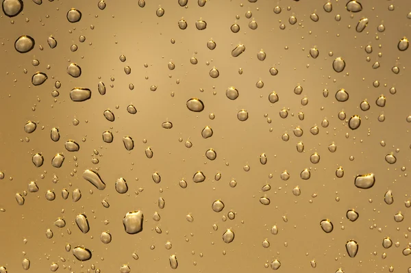 Gota de água em dourado — Fotografia de Stock
