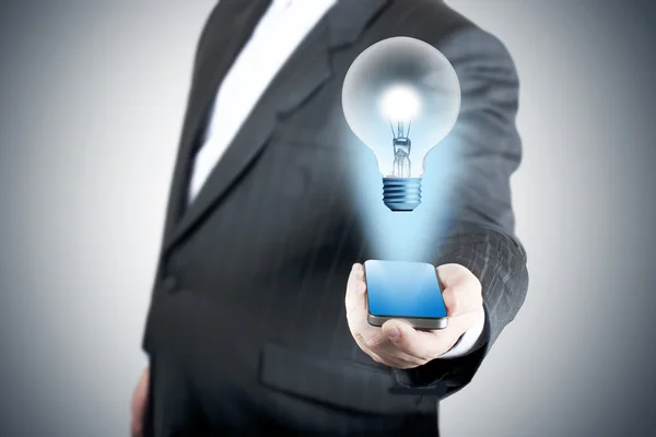 3D bulb coming out from touch screen mobile phone — Stock Photo, Image