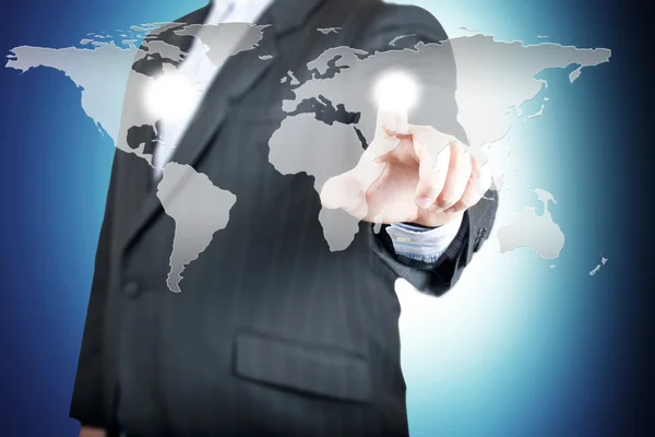 Business man pointing on the touch screen with world map — Stock Photo, Image