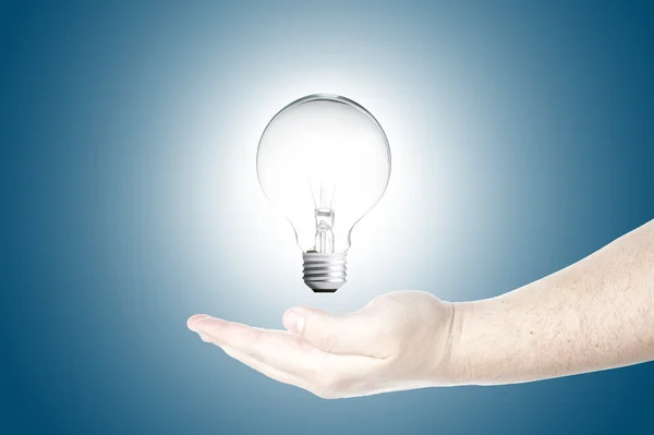 Light bulb in floating on Man's hand — Stock Photo, Image