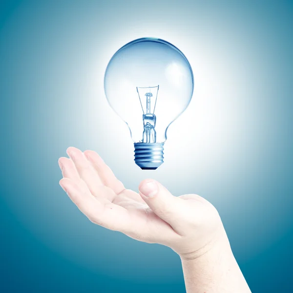 Light bulb in floating on Man's hand — Stock Photo, Image
