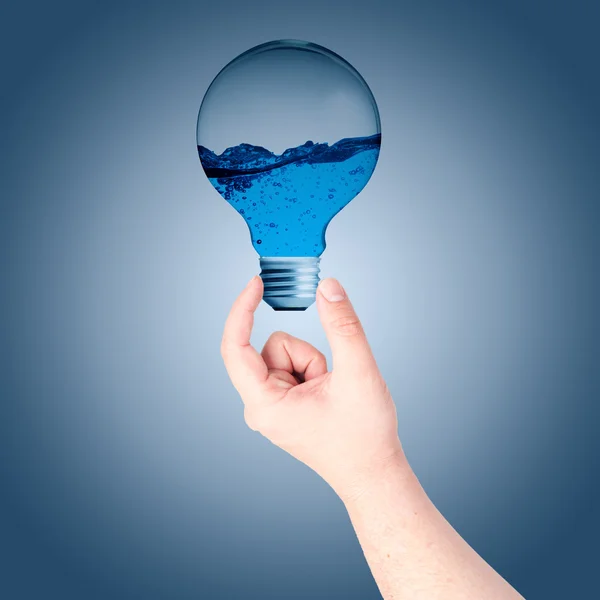 Man Hand holding on the light bulb with water inside — Stock Photo, Image