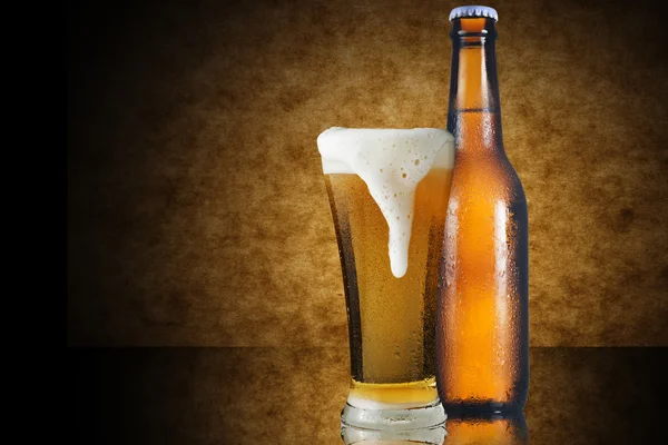 A glass of beer and beer bottle — Stock Photo, Image