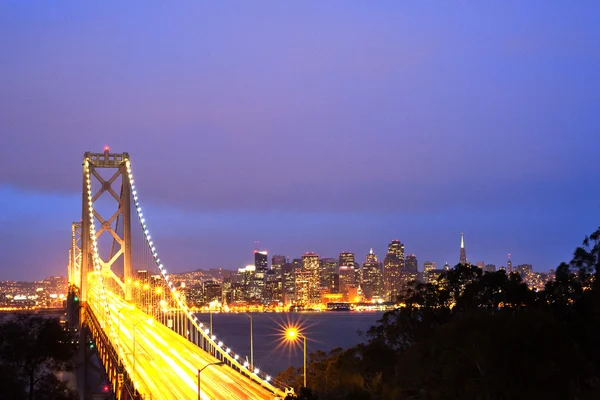 Bay Bridge at twilight with ocean in the foreground. — Stock Photo, Image