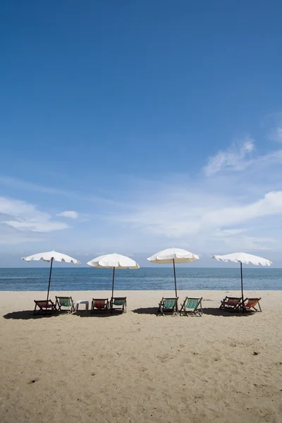 Beach chairs on sand beach Stock Picture