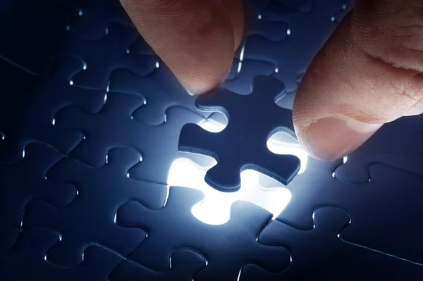 Missing jigsaw puzzle piece with light glow — Stock Photo, Image