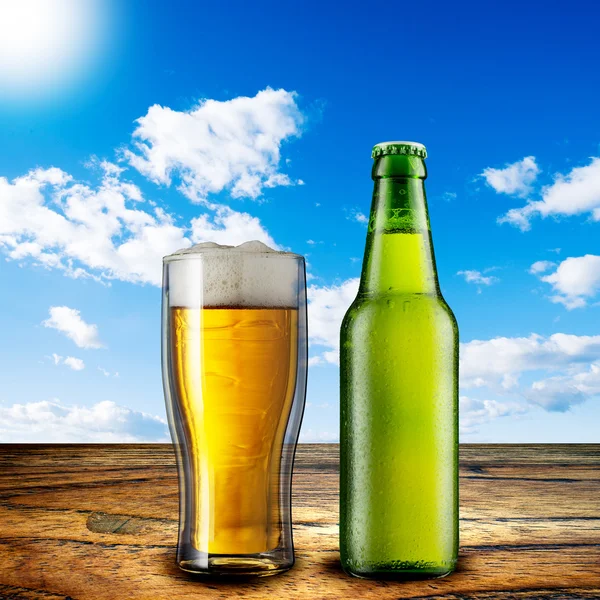 Glass of beer and beer bottle Stock Photo