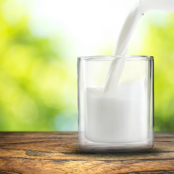 Pouring milk to glass — Stock Photo, Image
