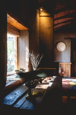 Beautiful rustic style interior of a countryside house with old objects like an traditional scale and wall clock