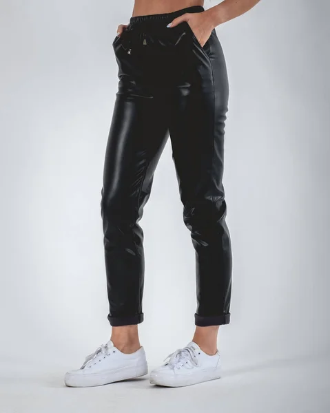 Sexy Girl Legs Feet Black Bright Leatherette Pants White Sneakers — 图库照片