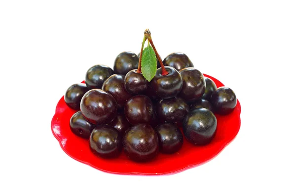 Ripe cherries in a small red platter — Stock Photo, Image