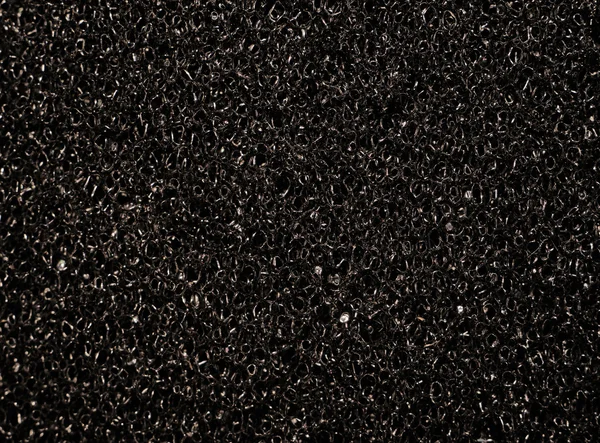 Texture black synthetic porous sponges as background — Stock Photo, Image