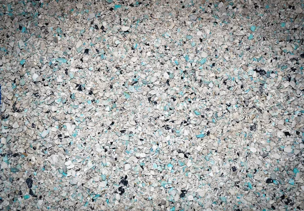 Background of small blue, gray, white and black small granules w — Stock Photo, Image