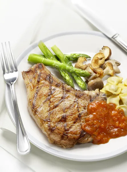 Grilled steak with tomato sauce and vegetables — Stock Photo, Image