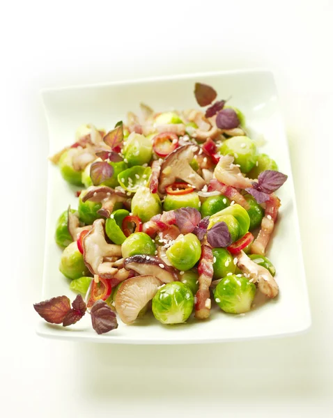 Sprouts with bacon and mushrooms — Stock Photo, Image