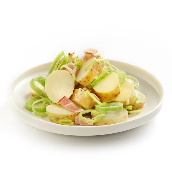 Tasty potato salad with leek and bacon — Stock Photo, Image