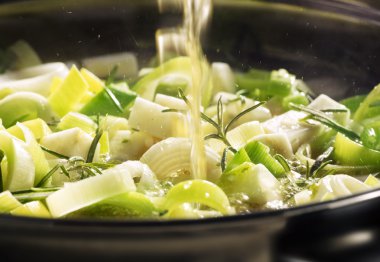 leek being cooked in a pan clipart