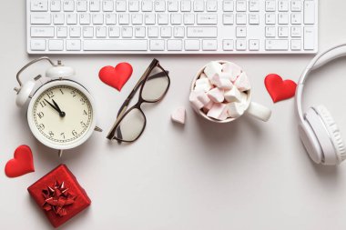 Desktop for valentine's day. Keyboard gift marshmallow on a gray table.