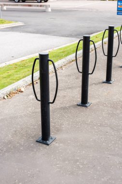 Three metal poles for locking bikes to.