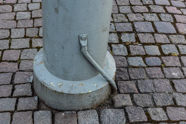 Electrical Grounding Cable Attached Metal Pole Cobblestone Street — Stock fotografie