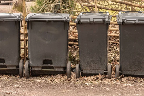 Four Grey Garbage Cans Wheels — стоковое фото