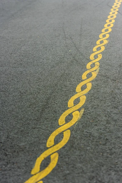 Yellow striped pattern painted on a road.