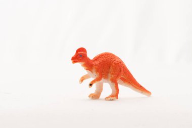 Plastic toy Corythosaurus dinosaur on white background.