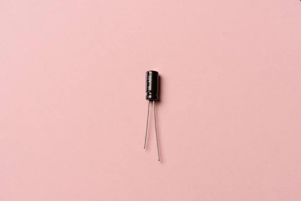 Black Small Capacitor Pink Background — 스톡 사진