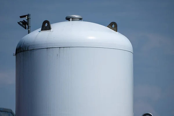 Top of large white metal gas tank.