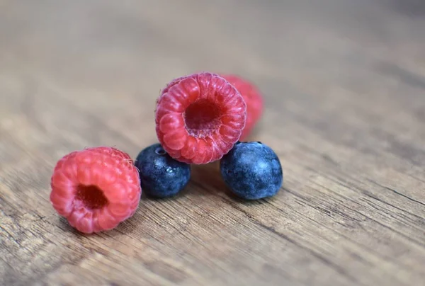 Ripe Raspberries Blueberries Wooden Brown Table — стоковое фото