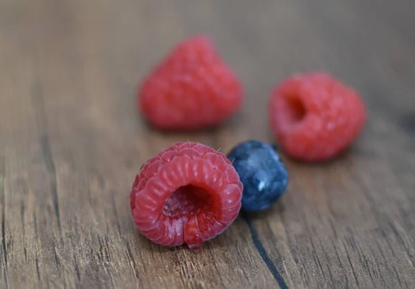 Ripe Raspberries Blueberries Wooden Brown Table — стоковое фото