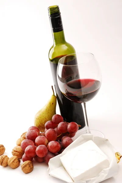 Grapes, cheese and a glass with red wine — Stock Photo, Image