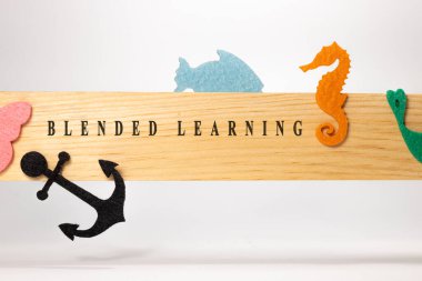 Written on a blended learning wood patterned surface. Education and child psychology.