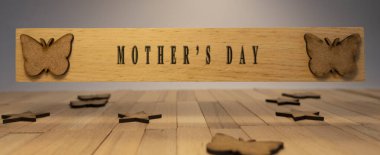 Mother's day written on wooden surface. Wooden concept. Celebrations and special occasions
