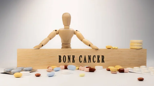 Bone Cancer disease. Written on wooden surface. In wood and medicine concept. white background. Diseases and treatments.