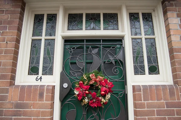 Red Brick Wall with a green Door and Window — Stock Photo, Image