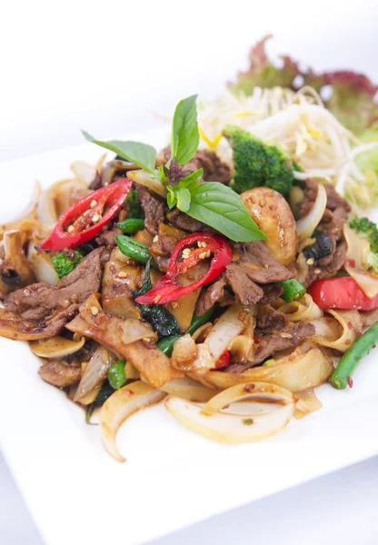 Stir fried flat rice noodles with basil sauce. — Stock Photo, Image