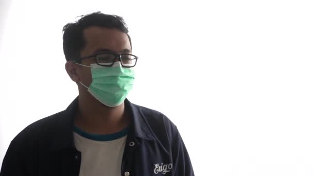 熱銃を操作しながらマスクをした若い男のキービデオ — ストック動画