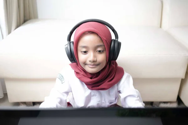 Cute Little Girl Wearing Red Hijab Doing Something Her Laptop — Stockfoto