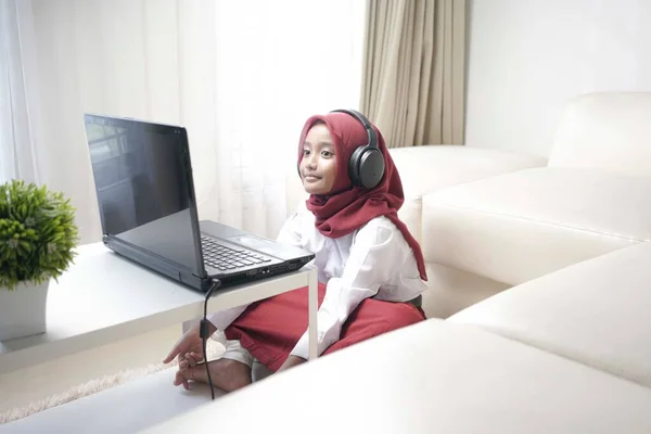 Cute Little Girl Wearing Red Hijab Doing Something Her Laptop — Stockfoto