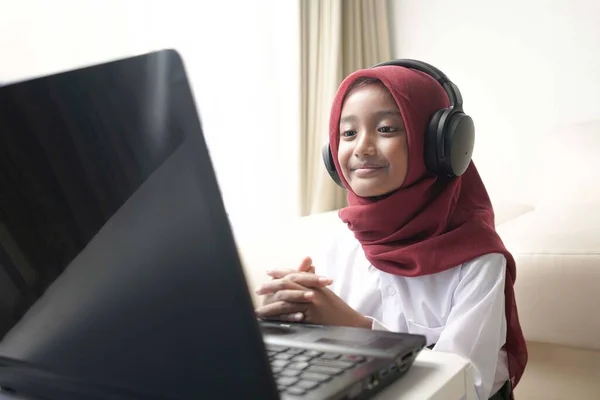 Cute Little Girl Wearing Red Hijab Doing Something Her Laptop — Stockfoto