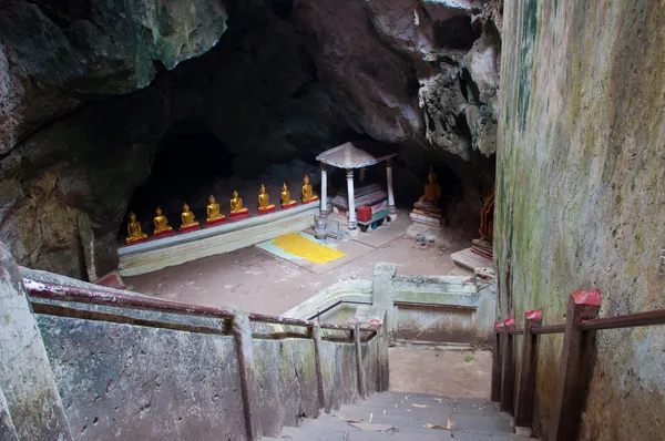 The entrance of the ancient cave with golden Buddha in Thailand — Stock Photo, Image